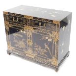 A TCC Chinese 20thC black lacquered chest, painted with birds and blossom, having two frieze drawers