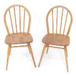 A pair of Ercol mid century ash and elm Windsor kitchen chairs, with solid seats, raised on turned l