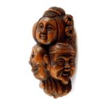 A Japanese late Taisho / early Showa period wooden netsuke of the heads of the Seven Immortals, sig