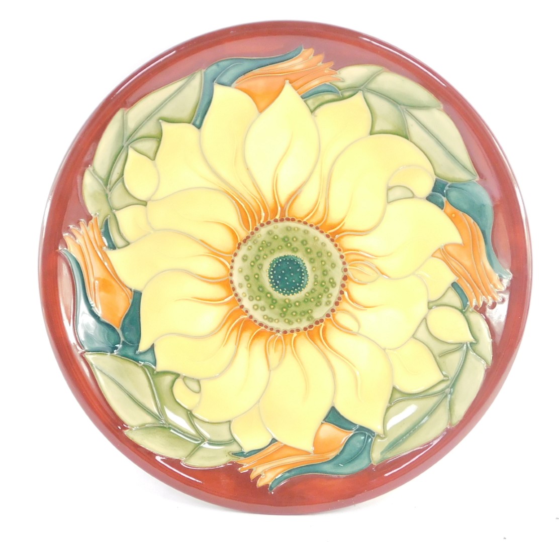 A Moorcroft pottery plate decorated in the Inca Sunflower pattern, painted and impressed marks, 26cm