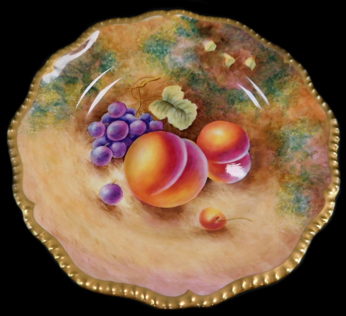 A Royal Worcester porcelain cabinet plate, signed Leaman, painted with peaches and black grapes, 22