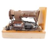 A Singer two tone electric sewing machine, serial number K10656348, cased.
