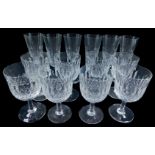 A set of eight heavy cut glass wine glasses, together with a set of six cut glass champagne flutes.