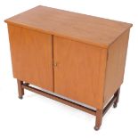 A mid century teak drinks cabinet trolley, the two drawers, one with fittings for cocktails apparel,