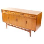 A G plan teak sideboard, with one long flanked by two short drawers, over four cupboard doors, raise