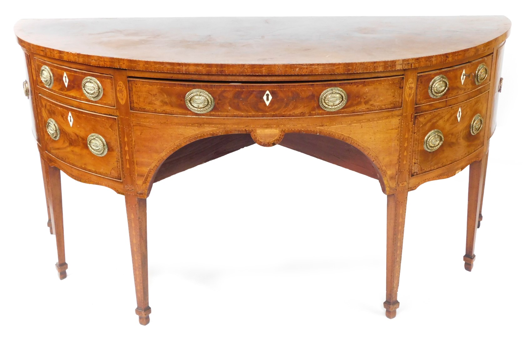 A George III mahogany demi lune sideboard, with cross banded and line inlaid top, an arrangement of