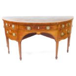 A George III mahogany demi lune sideboard, with cross banded and line inlaid top, an arrangement of