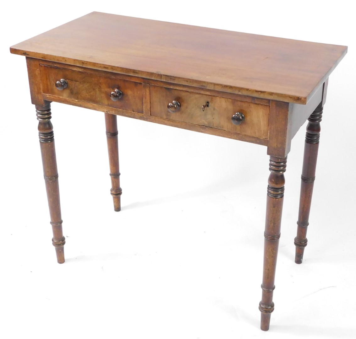 A late Georgian mahogany side table, with two frieze drawers, one lockable, raised on ring turned le