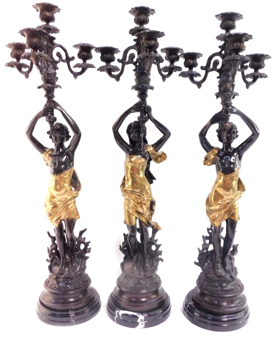 After Emile Bouchon (French, fl. 1880-1910). A garniture of three cast bronze and parcel gilt metal