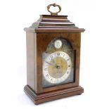 An Elliot of London walnut cased mantel clock, retailed by S T Hopper of Boston, 27cm high.