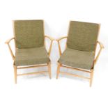 A pair of Ercol blonde elm and ash armchairs, with green loose cushions seats and backs.