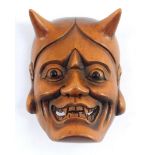 A Japanese late Taisho / early Showa period wooden netsuke carved as a Noh mask of Hannya, the jeal