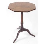 A late Georgian mahogany tilt top occasional table, the octagonal top raised on a ring turned column