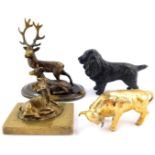 A Victorian loaded brass paperweight, cast as a recumbent deer, brass figure group of a stag and doe