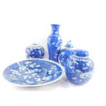 A group of Qing dynasty blue and white porcelain, decorated with prunus blossom against a cracked ic