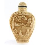 A Chinese imitation ivory snuff bottle, decorated in relief with figures in a garden, 71mm high.