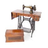 A Singer sewing machine table, with Egyptian model sewing machine, raised on a cast iron treadle bas