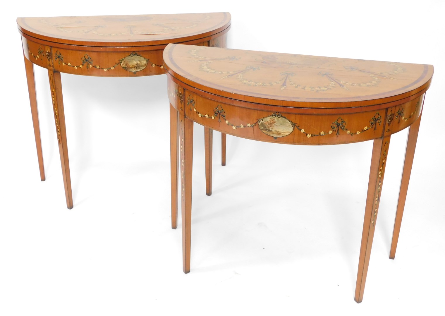 A pair of 19thC Sheraton revival hand painted satinwood demi lune card tables, with baize lined fold