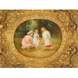 Continental School. Victorian children playing a garden with puppies, oil on board, 18.5cm high, 23.