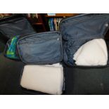 Two black suitcases, containing baby's blankets, together with two further black suitcases