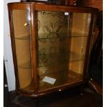 A mid 20thC walnut china cabinet, enclosing two glass shelves, with sliding doors, 117cm high, 105cm