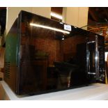 A Tricity microwave oven, in metalic black, model no TMG209.