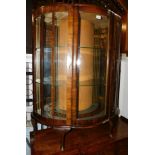 A mid 20thC walnut bowfront china cabinet, enclosing two glass shelves, 116cm high, 97cm, wide, 36cm