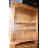 A pine bookcase, enclosing three adjustable shelves, 121cm high, 96cm wide, 31cm deep.