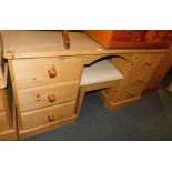 A waxed pine dressing table, 76cm high, 145cm wide, 43cm deep, with matching stool. (2)