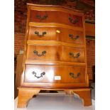 A reproduction yew wood serpentine fronted chest, of four drawers, 70cm high, 48cm wide, 36cm deep.