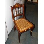 An early 19thC French mahogany dining chair, with cane seat.