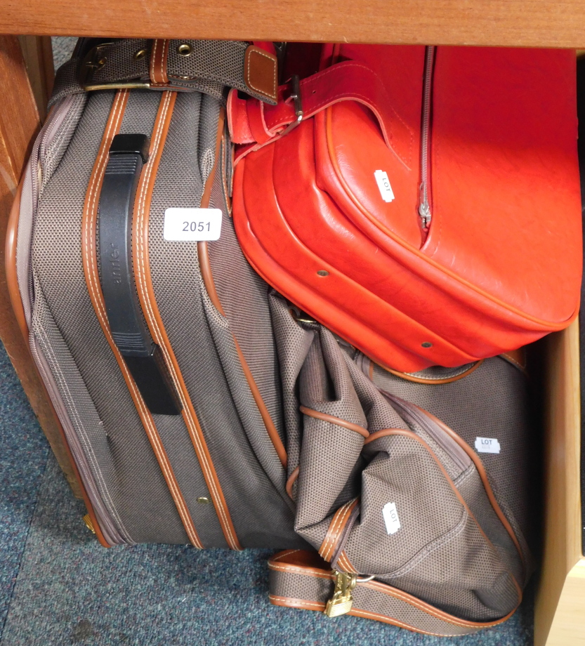 An Antler suitcase, holdall and a red leatherette case.