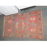 A short weave wool rug, red ground decorated with symmetrical blue geometric pattern, 138cm high,