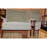 A two seater wooden framed sofa, upholstered in green fabric, together with a matching armchair. (