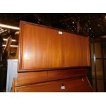 A vintage teak G-Plan record cabinet, with two sliding doors, 49cm high, 76cm wide, 46cm deep.