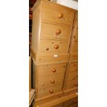 A pair of pine three drawer bedside chests, with bun handles, both 62cm high, 46cm wide, 43cm deep.