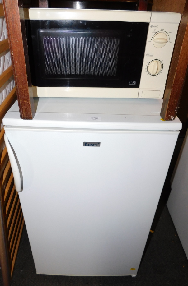 An LEC under counter fridge, model L5026W, together with a microwave. (2)