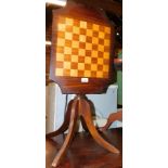 A reproduction mahogany tilt top table, with inlaid chess board, 51cm high, 50cm wide, 37cm deep.