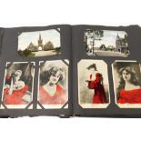 An early 20thC postcard album and contents, comprising various colour scenic postcards, musical post