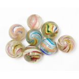Eight late 19th/early 20thC large marbles, each with a colour swirl decoration, nailsea style, some