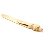 An early 19thC ivory clip or bookmark, of arrow form with dog head knop, 12cm high.