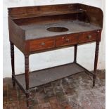 A Georgian mahogany tray top washstand, with central bowl recess and two frieze drawers on turned le