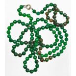 A string of jade coloured glass beads, each approx 4mm diameter, on a plain clasp, 116cm long.