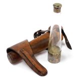 An early 20thC hunting flask, with glass body and silver plated cap ends, in a leather carrying satc