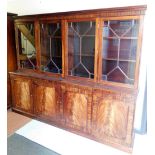 A Georgian style mahogany four door glazed bookcase, with molded cornice, four astragal glazed doors