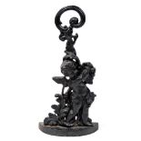 A cast iron doorstop or porter, of a cherub holding a vine, 45cm high.