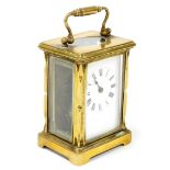 A gilt brass carriage clock, with time piece movement and enamel dial, 11cm high excluding handle. (