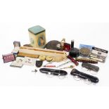 A group of trinkets and bygones, to include a tape reel, two pairs of reading glasses, a miniature d