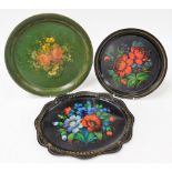 A group of Toleware trays, two in black with applied floral decoration and gilt banding, a further e