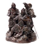 A Chinese bronzed resin figural group, of a seated bearded general with two attendants on a rock wor